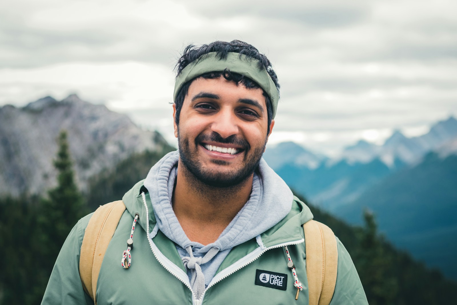 Casey Alvarado, founder and lead guide, smiling at a mountain summit